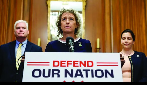 a woman stands at a podium 