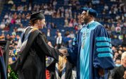 President Hemphill congratulates a student at the advanced degree commencement ceremony